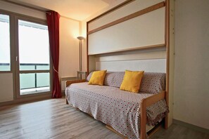 Enjoy a peaceful retreat with a single bed, headboard, and floor lamp.