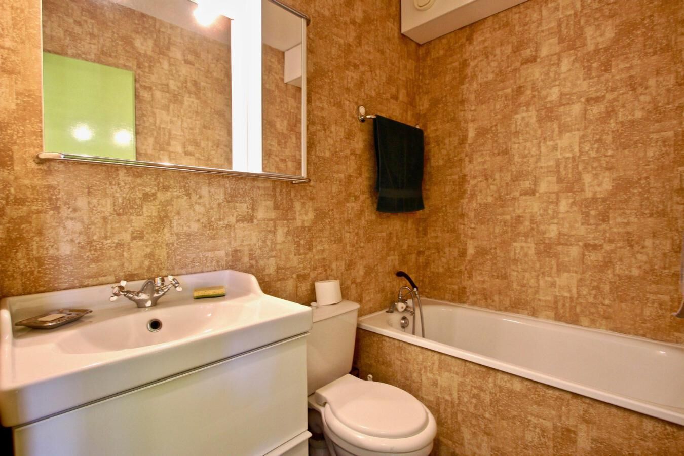 A bathroom with a sink, toilet, and bathtub.