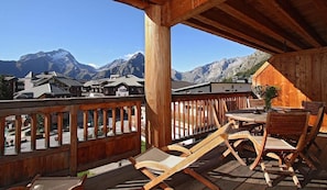 Enjoy breathtaking views of the surrounding mountains and village from this balcony.