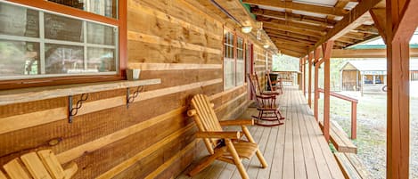 Relax on the covered porch with comfortable seating and enjoy the tranquil garden surroundings.