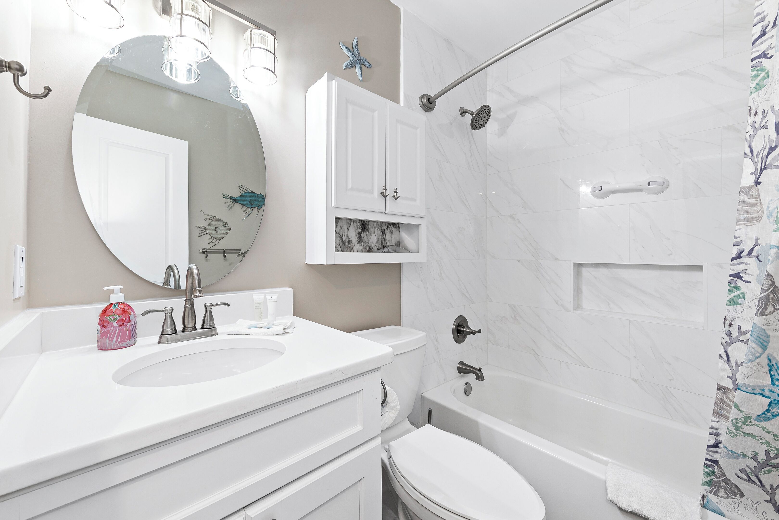 A bathroom with a sink, toilet, and bathtub.