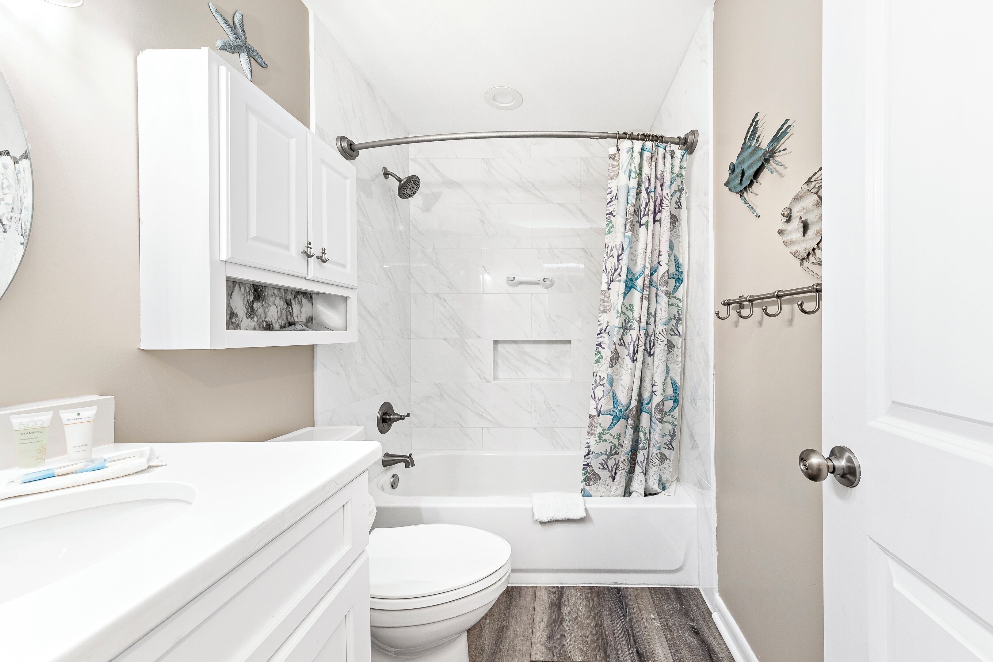 Une salle de bain avec douche, toilettes et lavabo.