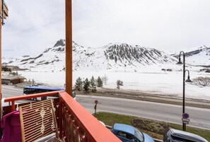 Enjoy breathtaking views of the snow-covered mountains from this balcony.