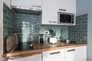 Enjoy cooking in this well-equipped kitchen with a sink, microwave, and toaster.