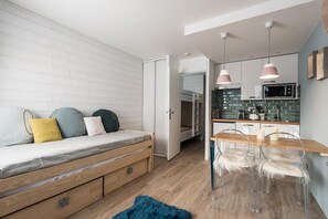 Cozy retreat with a bed, dining area, and kitchenette.