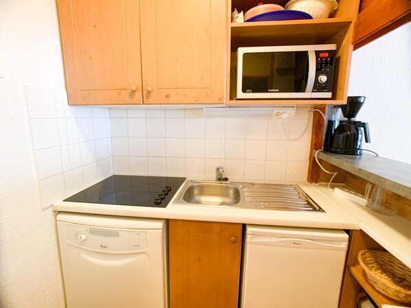 Prepare meals in this kitchen with a microwave, sink, and dishwasher.