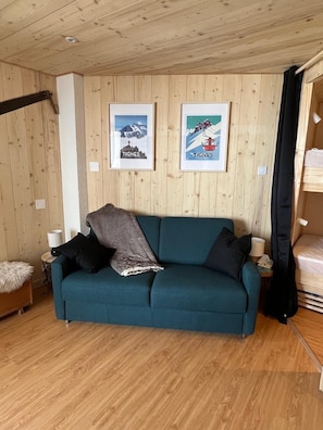 Relax in a warm and inviting space with a comfortable sofa, additional seating, and personal touches.