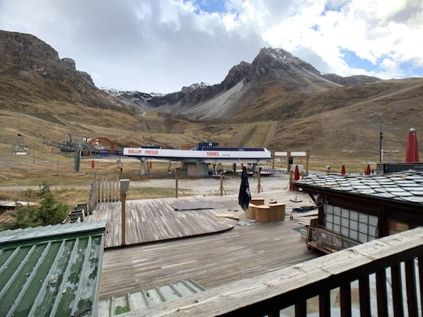 Relax on a simple deck with seating areas overlooking the surrounding mountains.