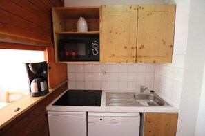 Kitchen features a sink, coffee maker, microwave, and two dishwashers.