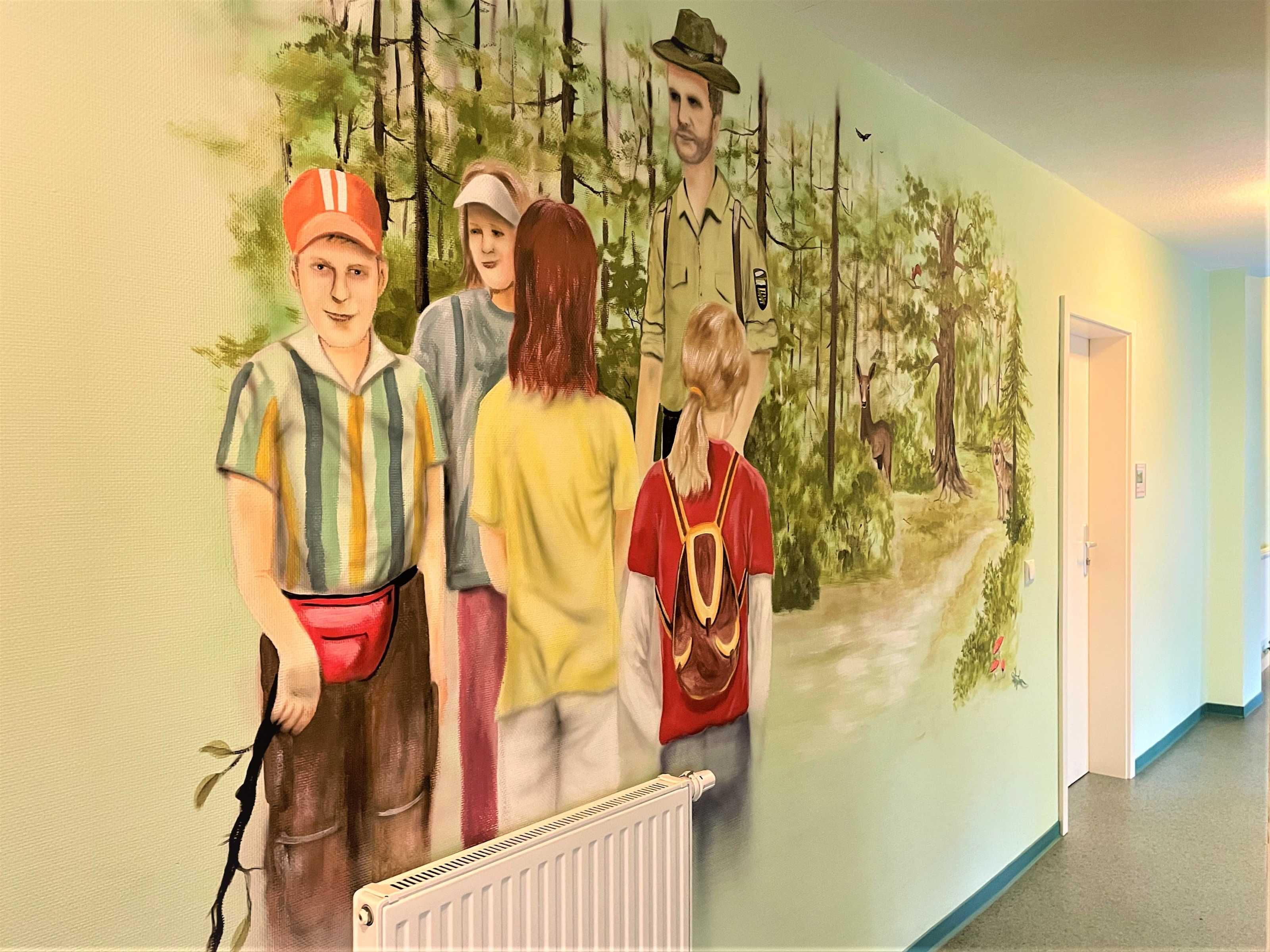 A mural of people in a forest setting on a wall.