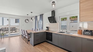A modern kitchen with a central island, a dishwasher, and a sink. - Villa Marko by Aneo Travel (Ledenice)
