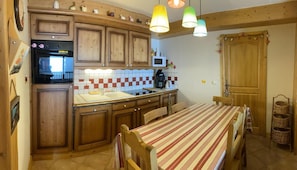 Enjoy cooking and dining in this fully equipped kitchen with a stove, coffee maker, and sink.