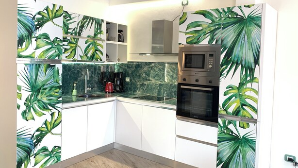 A modern kitchen with white cabinets, a built-in microwave, and a coffee maker. - Center Salo’, near to Duomo,  to Vittoriale D’Annunzio (Salò)