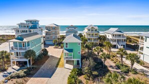 A beachfront property with multiple houses, a paved driveway, and a view of the ocean. - Merry Mermaid - Gulf view, Easy beach access, Family and pet friendly (Cape San Blas)