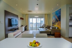 Club Suite | Living area | 55-inch LCD TV with cable channels, TV - AURA SUITES (Dar es Salaam)