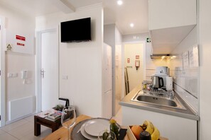 A modern kitchen with a built-in microwave, a coffee maker, and a sink.