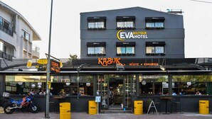 A building with a sign for 'Eva Boutique Hotel' and a restaurant named 'KABUK'.