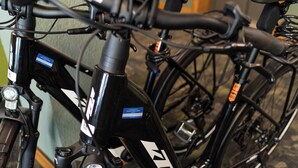 A close-up of a bicycle with a black frame and white branding, positioned indoors with a patterned carpet floor. - Hotel & Spa Gut Matheshof, BW Signature Collection (Rieden)