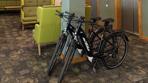 A lobby with green seating, an elevator, and bicycles. - Hotel & Spa Gut Matheshof, BW Signature Collection (Rieden)