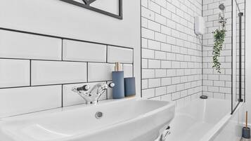 Deep-soaking bathtub, towels, soap, toilet paper