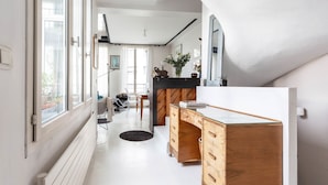 A modern kitchen with a wooden counter and cabinets, large windows, and a view of the outdoors. - White House, by Veeve (Paris)