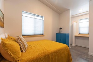 2 habitaciones, escritorio y tabla de planchar con plancha