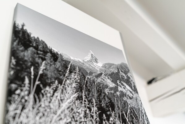 A black and white photograph of a mountainous landscape with trees and a peak. - Haus La Rocca by Zermatt Premium Apartments (Zermatt)