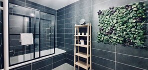 Bathtub, hair dryer, towels, toilet paper
