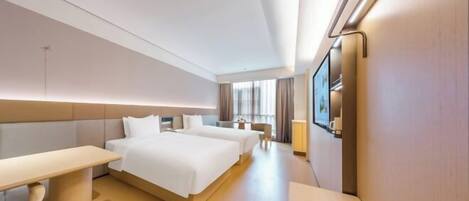 A modern hotel room with a large bed, a desk, and a TV.