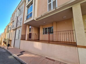 A multi-story residential building with balconies and a tiled ground floor. - APARTMENT WITH 2 TERRACES AND PARKING IN THE SAME BUILDING (Cartagena)