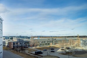 A modern building complex with multiple parking areas and a clear sky.