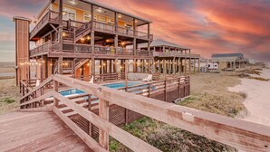 A multi-story wooden building with a pool, deck, and beach view. - Beachfront, Huge Deck and Private Heated Pool (Bolivar Peninsula)