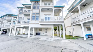 A row of white buildings with blue accents, featuring balconies and large windows. - Renovated PCB Studio, 2 Min Walk To Laguna Beach! (Panama City Beach)