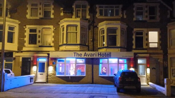 The Aviari Hotel with a sign above the entrance, a parking area, and a car parked in front. - The Avari Hotel (Blackpool)