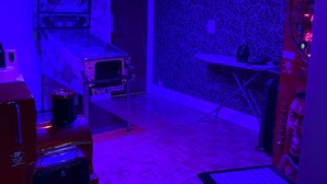 A room with a patterned wall, a small table, and a toy train. - The Avari Hotel (Blackpool)