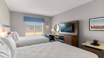 Desk, laptop workspace, iron/ironing board, bed sheets