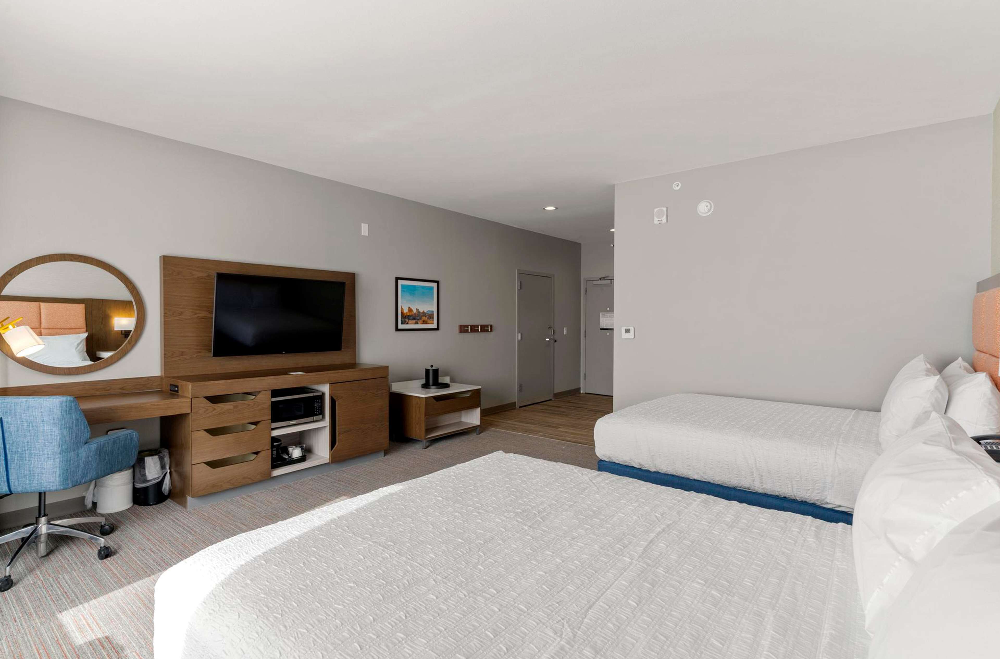 Desk, laptop workspace, iron/ironing board, bed sheets