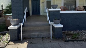 A residential house with a front porch, a blue door, and a number '608' above the entrance. - Cheerful Downtown 3 Bedroom home in the historic area of Columbus (Columbus)
