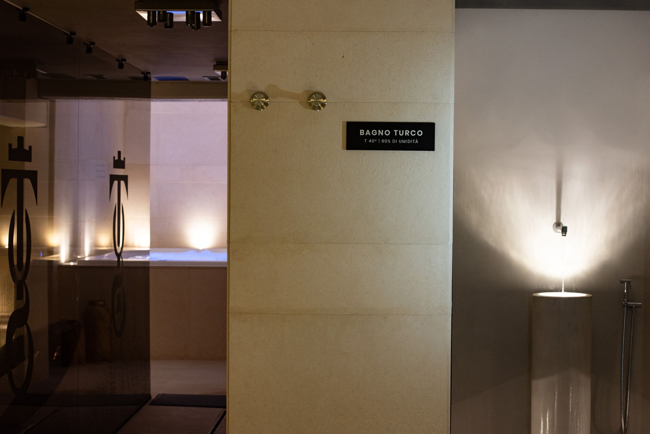 A bathroom with a sign reading "BAGNO TURCO" and a shower area.