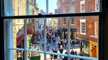 A busy street scene through a window with multiple panes.