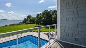 A pool with a view of a lake and trees. - Minutes from Downtown Easton and St. Michaels | Pool | Private Dock | Luxury (Royal Oak)