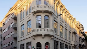 A historic building with a curved facade, large windows, and a prominent entrance.