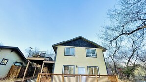 A two-story house with a balcony, a garage, and a driveway. - The Apartment Suite! Private Hot Tub w/ Mountain Views (Colorado Springs)