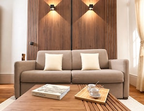 Un salon moderne avec un canapé, une table basse et un livre.