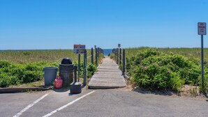 A wooden boardwalk leading to the beach with a 'NO PARKING ANY TIME' sign. - Sands Townhouses (Old Orchard Beach)