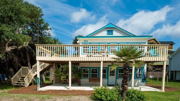 A two-story house with a balcony, a porch, and a staircase leading to the upper level. - Surfs Up,  Second Row, Upper Level Unit (Folly Beach)