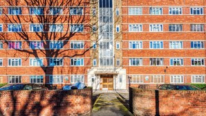 A multi-story brick building with a central entrance labeled "Harwood Court." - Hardwood Home  - One Bedroom Apartment, Sleeps 2 (London)
