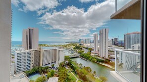 A high-rise building with a view of a marina and a river.