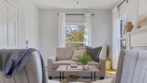 A cozy living room with a sofa, a coffee table, and a side table. - Quaint and Cozy Historic Home in Downtown Weatherford (Weatherford)