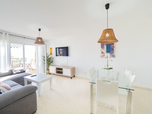 Relax in this stylish living room with a sofa, coffee table, and dining area, perfect for unwinding.